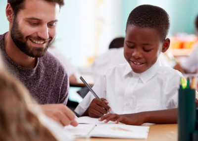 male pupil, teacher, primary school, writing